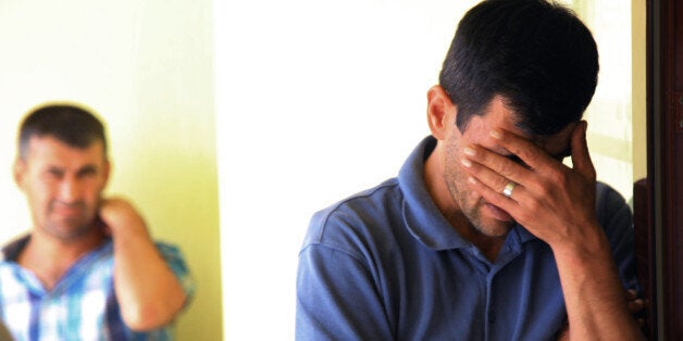 Abdullah Kurdi, 40, father of Syrian boys Aylan, 3, and Galip, 5, who were washed up drowned on a beach near Turkish resort of Bodrum on Wednesday, cries as he waits for the delivery of their bodies outside a morgue in Mugla, Turkey, Thursday, Sept. 3, 2015.(AP Photo/Mehmet Can Meral)