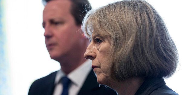 Prime Minster David Cameron and Home Secretary Theresa May speak to Home Office Immigration Enforcement officers at a property where six immigrants were arrested in Slough, Berkshire.