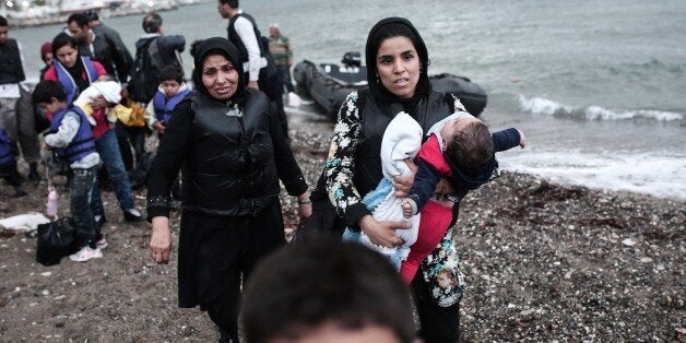 Afghan migrants arrive on a beach on the Greek island of Kos, after crossing a part of the Aegean Sea between Turkey and Greece, on May 27, 2015. AFP PHOTO / Angelos Tzortzinis (Photo credit should read ANGELOS TZORTZINIS/AFP/Getty Images)