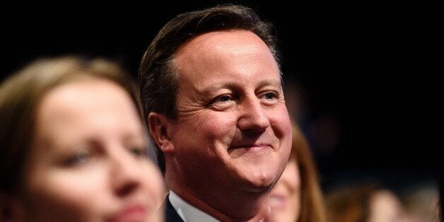 British Prime Minister David Cameron listens as British Chancellor of the Exchequer George Osborne addresses delegates, on the second day of the annual Conservative party conference in Manchester, north west England, on October 5, 2015. AFP PHOTO / LEON NEAL (Photo credit should read LEON NEAL/AFP/Getty Images)