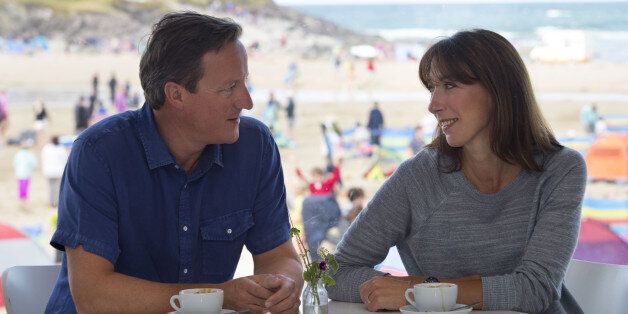 Prime Minister David Cameron with wife Samantha Cameron on Polzeath beach in Cornwall last year. Photo by Matthew Horwood - WPA Pool /Getty Images