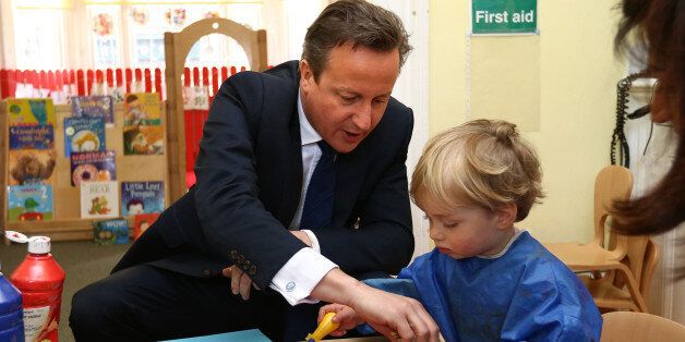 Prime Minister David Cameron paints with vegetables during a visit to a children's nursery in London, as Mr Cameron admitted it will "take time" to get plans to double free childcare provision right amid warnings the system faces "meltdown" unless the changes are fully funded.