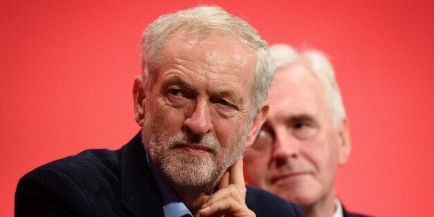 Leader of the opposition Labour Party Jeremy Corbyn (L) sits by shadow chancellor John McDonnell on day two of the annual Labour party conference in Brighton on September 28, 2015. AFP PHOTO / LEON NEAL (Photo credit should read LEON NEAL,LEON NEAL/AFP/Getty Images)