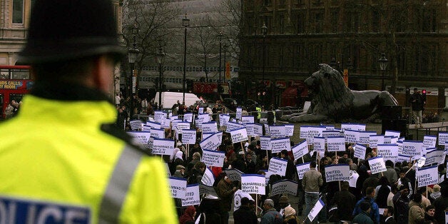 A police officer looks on at the Islamaphobia rally organised by a coalition of moderate Muslim groups including the Muslim Association of Britain, the UK Islamic Mission and the Islamic Society of Britain in Trafalgar Square, London, Saturday February 11, 2006. Thousands of Muslims will gather today in London to protest at the publication of controversial cartoons caricaturing the Prophet Mohammed. Christian groups are also joining the United Against Incitement and Islamophobia rally in Trafalg