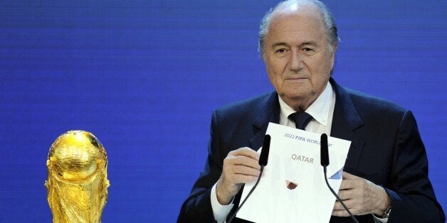 FIFA President Sepp Blatter holds up the name of Qatar during the official announcement of the 2022 World Cup host country. PHILIPPE DESMAZES/AFP/Getty Images