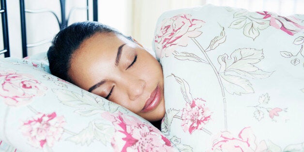 portrait of young woman asleep in bed