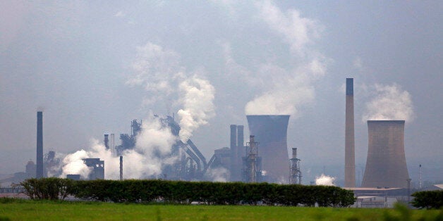 Vapor rises from cooling towers at the steel works operated by Tata Steel Ltd. in Scunthorpe, U.K., on Monday, May 20, 2013. Tata Steel Ltd., India's biggest producer, is considering selling some of its U.K. assets as a weakening economy erodes demand leaving factories underutilized, two people with knowledge of the matter said. Photographer: Paul Thomas/Bloomberg via Getty Images