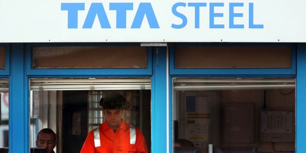 A Tata Steel worker checks his phone after a meeting at the Tata Steel plant in Motherwell, as fears about fresh job losses in the steel industry have been confirmed after Tata announced plans to cut 1,200 posts.