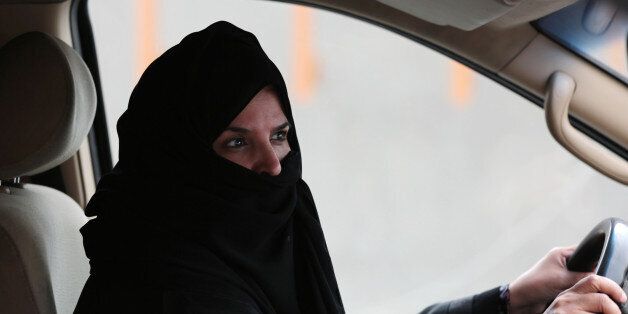 Aziza Yousef drives a car on a highway in Riyadh, Saudi Arabia, Saturday March 29, 2014, as part of a campaign to defy Saudi Arabia's ban on women driving. (AP Photo/Hasan Jamali)
