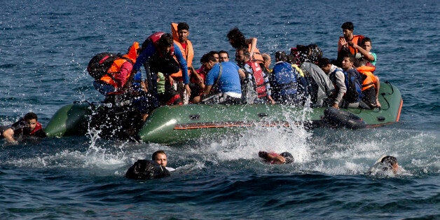 Migrant whose boat stalled at sea while crossing from Turkey to Greece swim to approach the shore of the island of Lesbos, Greece, on Sunday, Sept. 20, 2015. A boat with 46 migrants or refugees has sunk Sunday in Greece and the coast guard says it is searching for 26 missing off the eastern Aegean island of Lesbos. (AP Photo/Petros Giannakouris)