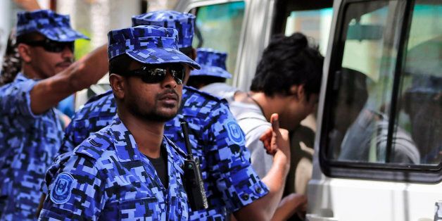 Maldivian police force guard after the arrest of Vice President Ahmed Adeeb in Male, Maldives, Saturday, Oct. 24, 2015. Police in the Maldives arrested Adeeb on Saturday in connection with an explosion aboard the president's boat last month that authorities have said was an assassination attempt. (AP Photo/Sinan Hussain)