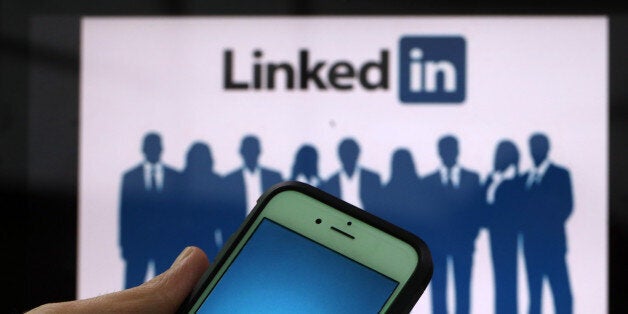 The LinkedIn Corp. logo is displayed on the screens of an Apple Inc. iPhone 6 and a laptop in this arranged photograph taken in London, U.K., on Friday, May, 15, 2015. Facebook Inc. reached a deal with New York Times Co. and eight other media outlets to post stories directly to the social network's mobile news feeds, as publishers strive for new ways to expand their reach. Photographer: Chris Ratcliffe/Bloomberg via Getty Images