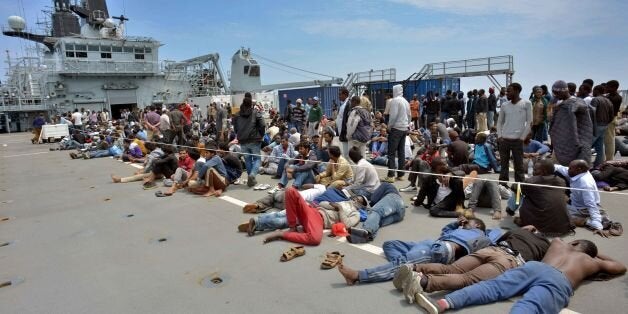 Royal Marines from HMS Bulwark help rescue migrants stranded on a boat, thirty miles off the Libyan coast.