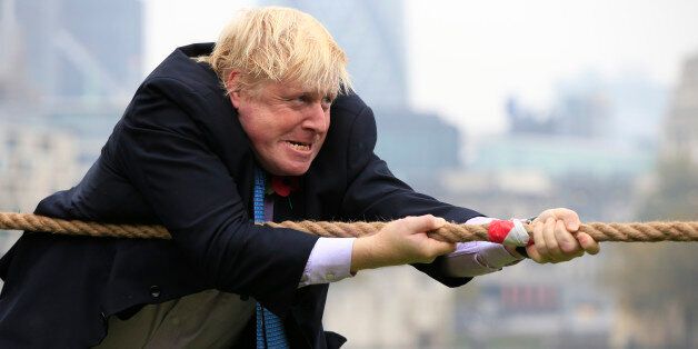 Mayor of London Boris Johnson takes part in a tug of war with personnel from the Royal Navy, the Army and the Royal Air Force at the launch of London Poppy Day, on Potters Field, next to City Hall in London.