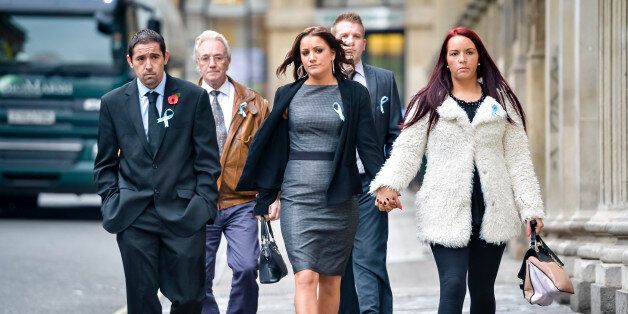 Friends and family of Becky Watts, including her grandfather, John Galsworthy (second left), wear blue ribbons in support of Becky Watts as they arrive at Bristol Crown Court on the first day of Nathan Matthews defence case in the murder trial.