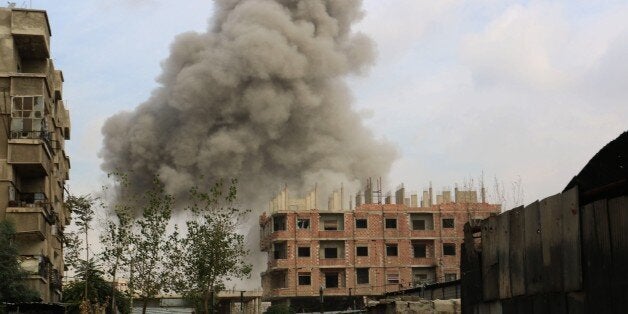 Smoke rises after the war crafts belonging to the Syrian army bombed opposition-controlled district of Ayn Tarma in Damascus, Syria on October 28, 2015. (Photo by Ala Muhammed/Anadolu Agency/Getty Images)