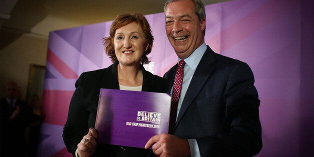 THURROCK, ENGLAND - APRIL 15: UK Independence Party (UKIP) leader Nigel Farage and deputy chairman, Suzanne Evans, pose with the party manifesto during the launch on April 15, 2015 in Thurrock, England. The party's proposals include extra money for the NHS, a minimum of 2 per cent of GDP to be spent on defence and a five-year ban on unskilled immigration. Britain goes to the polls in a general election on May 7. (Photo by Carl Court/Getty Images)