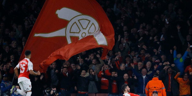 Arsenal's Olivier Giroud, right, celebrates after scoring during the Champions League Group F soccer match between Arsenal and Bayern Munich at Emirates stadium in London Tuesday, Oct. 20, 2015. (AP Photo/Kirsty Wigglesworth)