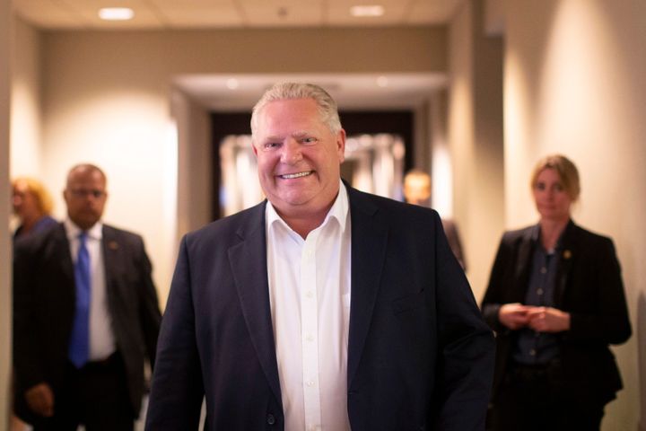 Ontario Premier Doug Ford walks into a holding room before speaking to journalists about his first year in office, in Toronto on June 7, 2019.