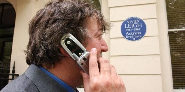 Actor and writer Stephen Fry poses outside 54 Eaton Square in London - the former home of actress Vivien Leigh - during the launch of 'Handheld History' . The innovative new guide for mobile phone users links them to the lives of famous figures commemorated with English Heritage Blue Plaques in Central London.