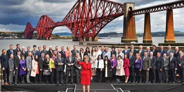 EDINBURGH, SCOTLAND - MAY 09: First Minister and leader of the SNP Nicola Sturgeon is joined by the newly elected members of parliament as they gather in front of the Forth Rail Bridge on May 9, 2015 in South Queensferry, Scotland. Back (L-R) Stuart McDonald, Callum McCaig, Patrick Grady, Stewart McDonald, Allison Thewliss, Stuart Donaldson, Ronnie Cowan, Paul Monaghan, Pete Wishart, Brendan O'Hara, Hannah Bardell, John Nicolson, Michelle Thomson, Natalie McGarry, Tasmina Ahmed-Sheikh, Eilidh W