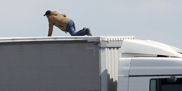 Migrants trying to board UK bound lorries on the main road into Calais ferry port.