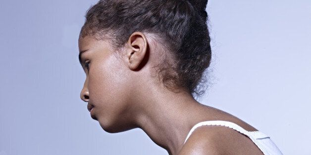 image of somber black girl with done up hair