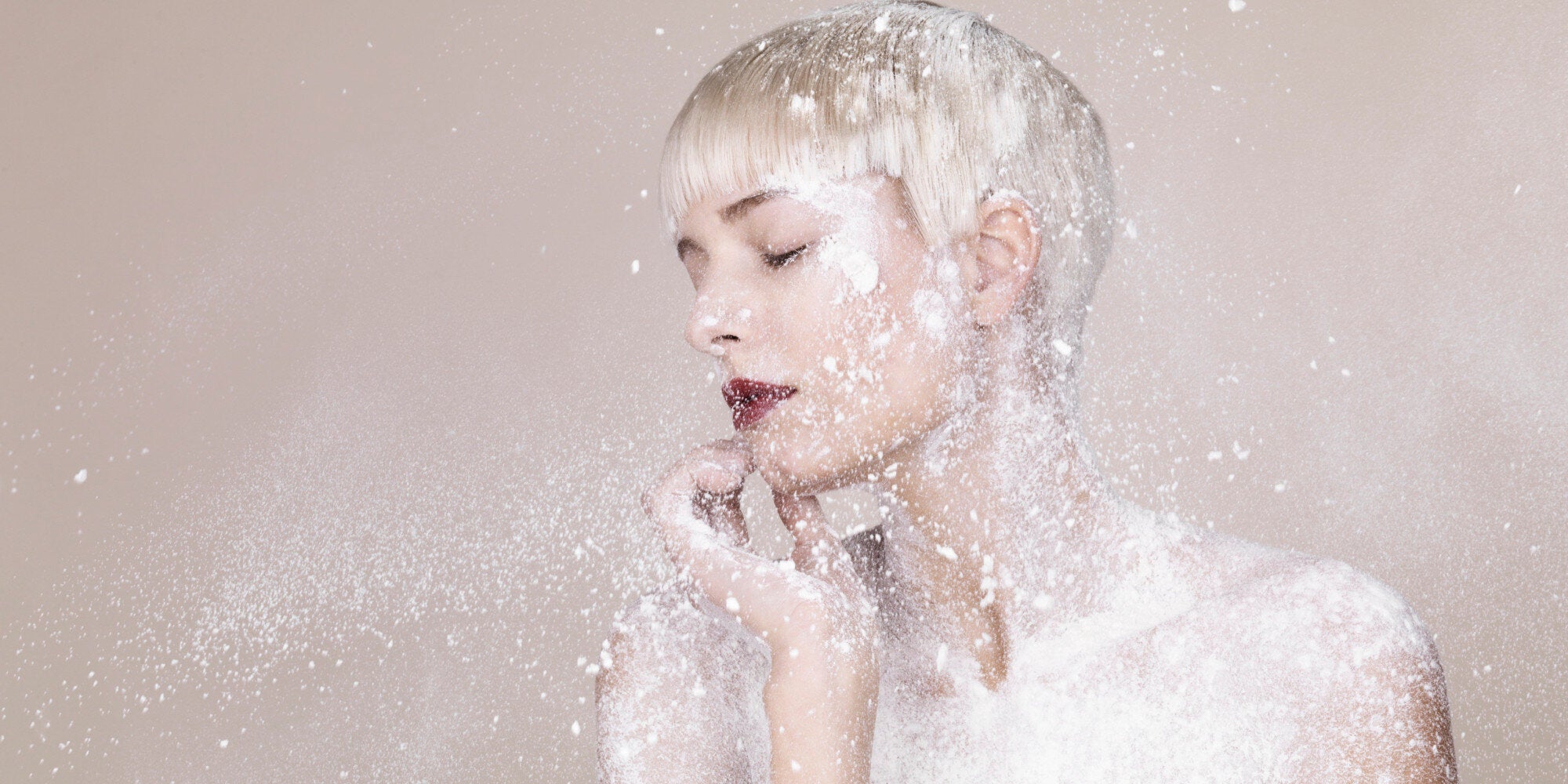 putting baby powder on face