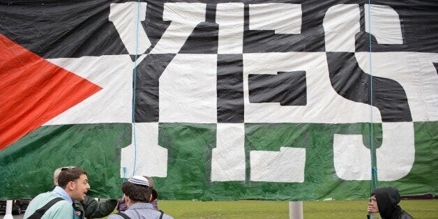 Young Jewish men argue with Pro-Palestinian supporters beside a giant banner calling for a recognised Palestinian State, in Parliament Square, central London on October 13, 2014. British lawmakers were to hold a non-binding vote Monday on recognising Palestine although government ministers will abstain in a sign of how political sensitive the issue is. The debate is being closely watched internationally after Sweden incurred Israeli wrath this month for saying it will recognise Palestine. While