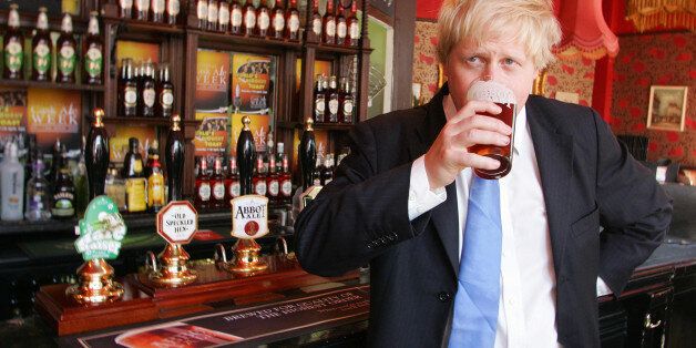 London Mayor Boris Johnson enjoys a pint of Greene King's Abbot Ale at the King's Arms pub on Tooley St in London, to celebrate National Cask Ale Week and to urge people to support their local pub.