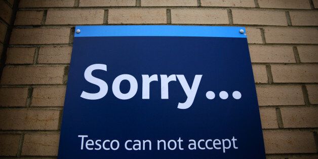 A 'Sorry' logo sits on a customer notice outside a Tesco Extra supermarket store, operated by Tesco Plc, in the Old Kent Road district of London, U.K., on Thursday, Sept. 25, 2014. Tesco may be reduced by more than one credit level, taking it into speculative grade, if the findings of a probe into the accounting errors prompt the ratings company to lower its assessment of Tesco's management and governance to 'weak,' Standard & Poor's said yesterday. Photographer: Matthew Lloyd/Bloomberg via Gett