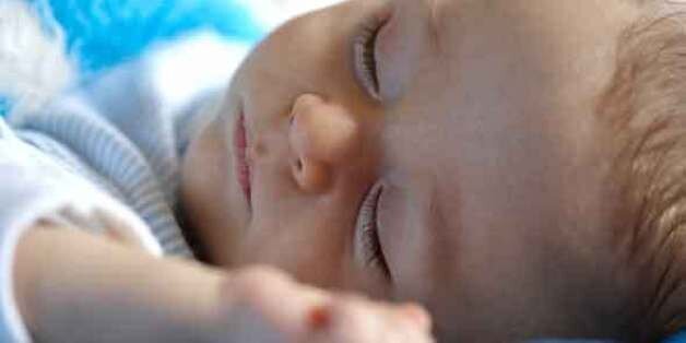 Mother holding sleeping baby