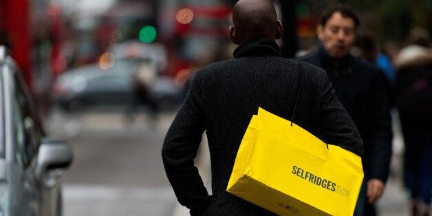 LONDON, ENGLAND - DECEMBER 26: Shopper carries a Selfridges bag on Oxford Street during the annual boxing day sales on December 26, 2014 in London, England. (Photo by Ben A. Pruchnie/Getty Images)
