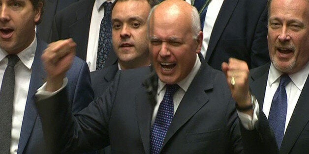 Works and Pensions Secretary Iain Duncan Smith punches the air as he listens to Chancellor of the Exchequer George Osborne deliver his Budget statement to the House of Commons, London.