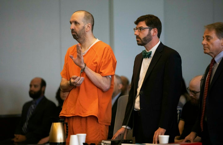 Craig Hicks, in handcuffs, pleaded guilty to three counts of first-degree murder in the 2015 killings of three young Muslims in North Carolina.