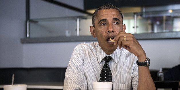 US President Barack Obama eats a french fry while meeting with supporters about voter registration at OMG Burgers on September 20, 2012 in Miami, Florida. Obama is traveling to Florida for the day to participate in a taping for Univision in Miami before attending a campaign event in Tampa. AFP PHOTO/Brendan SMIALOWSKI (Photo credit should read BRENDAN SMIALOWSKI/AFP/GettyImages)