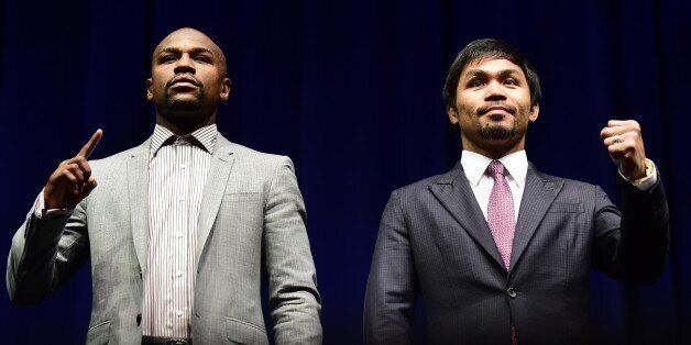 Boxers Manny Pacquiao (R) from the Philippines and Floyd Mayweather from the US gesture while posing during a press conference on March 11, 2015 in Los Angeles, California, to launch the countdown to their May 2, 2015 super-fight in Las Vegas. AFP PHOTO/ FREDERIC J. BROWN (Photo credit should read FREDERIC J. BROWN/AFP/Getty Images)