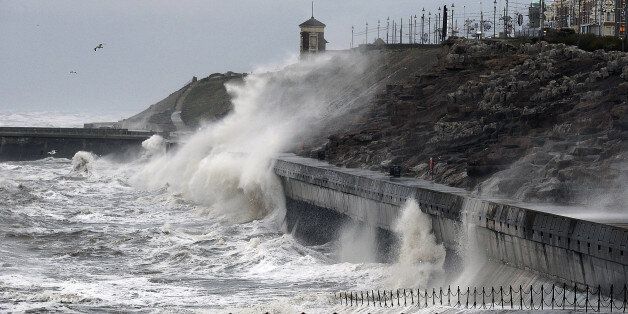 Large waves hit the seafront at Blackpool, as the remnants of Hurricane Gonzalo blew into Britain, causing rush-hour travel misery for road, rail and air travellers.