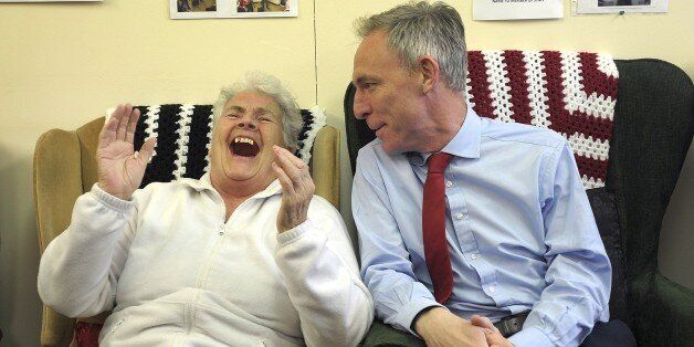 Leader of the Scottish Labour Party Jim Murphy (R) speaks with pensioner Margaret McLaughlin as he campaigns at the Donald Dewar Day Centre in the Yoker area of Glasgow in Scotland, on April 29, 2015, ahead of a general election in Britain on May 7, 2015. AFP PHOTO / ANDY BUCHANAN (Photo credit should read Andy Buchanan/AFP/Getty Images)