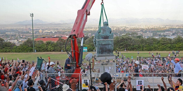 CAPE TOWN, SOUTH AFRICA APRIL 9 (SOUTH AFRICA OUT): Students celebrate as the Cecil John Rhodes statue is removed at the University of Cape Town on April 9, 2015 in CapeTown, South Africa. After nearly a month of protesting, sit-ins and relentless meetings by students, the statue of British colonialist will finally be removed. (Photo by Nardus Engelbrecht/Gallo Images/Getty Images)