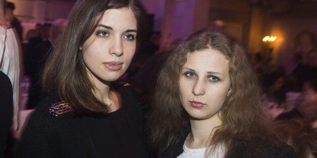 Nadezhda Tolokonnikova (L) and Maria Alyokhina (R) of Russian punk protest group Pussy Riot arrive for the Cinema for Peace gala in Berlin, on February 10, 2014. Cinema for Peace is a worldwide initiative, promoting humanity through film and takes place amongst others on the sidelines of the Berlinale International Film Festival. AFP PHOTO / JOHANNES EISELE (Photo credit should read JOHANNES EISELE/AFP/Getty Images)