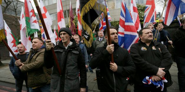 Members of Britain First, a far-right nationalist political party, protest across the street from London Central Mosque during prayers in Regent's Park, London, Friday, April 3, 2015. (AP Photo/Tim Ireland)
