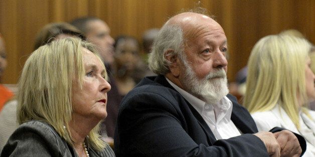 Parents of the late Reeva Steenkamp, June, left, and Barry Steenkamp, right, attend the murder trial of Oscar Pistorius in Pretoria, South Africa, Friday, Aug. 8, 2014. Final arguments by the defense entered a second day in his murder trial of the once-celebrated athlete who fatally shot his girlfriend, Reeva Steenkamp, through a toilet cubicle door in his home on Valentine's Day last year. (AP Photo/ Herman Verwey, Pool)