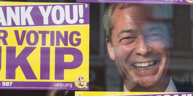 UKIP leader Nigel Farage looks out of the window of the UKIP campaign headquarters in Clacton, after last night's by-election victory.