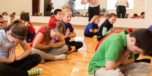 Children meditating in gym class