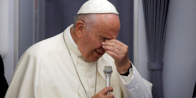 In this photo taken on Sunday, July 12, 2015, Pope Francis meets the media during an airborne press conference aboard the airplane directed to Rome, at the end of his Apostolic journey in Ecuador, Bolivia and Paraguay. (AP Photo/Gregorio Borgia)