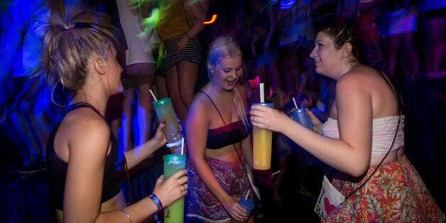 KUTA, INDONESIA - NOVEMBER 25: Teenagers attend a party in a nightclub during Australian 'schoolies' celebrations following the end of the year 12 exams on November 25, 2013 in Kuta, Indonesia. Every year over 3000 students descend on destinations such as Bali, Thailand, Fiji and Cambodia to celebrate 'Schoolies Week', which marks the end of the school year. Destinations such as Kuta in Bali are often chosen because of cheap alcohol and all night parties. (Photo by Agung Parameswara/Getty Imag