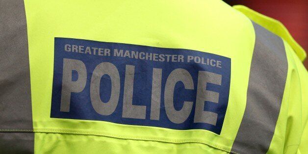 Greater Manchester Police signage on a policeman's jacket