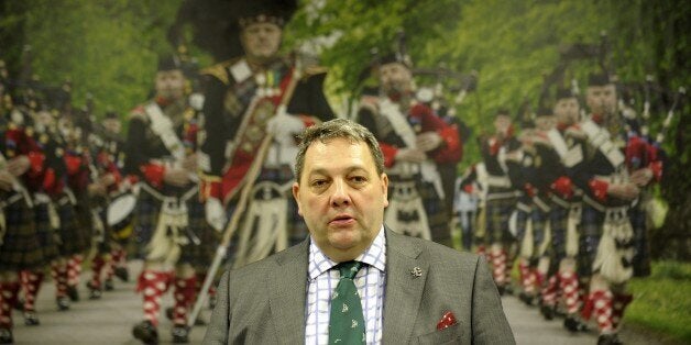 UK Independence Party (UKIP) member of the European Parliament David Coburn waits for leader of the Nigel Farage to address a rally to put forward the case against Scottish independence in Glasgow on September 12, 2014. AFP PHOTO/ ANDY BUCHANAN (Photo credit should read Andy Buchanan/AFP/Getty Images)