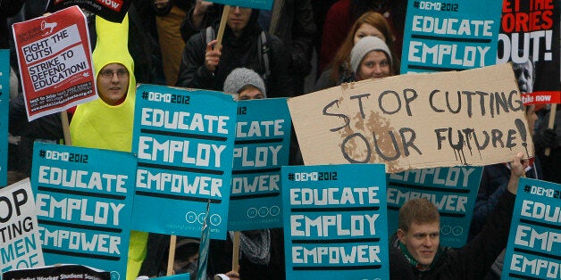 Demonstrators take part in a student protest against British government reforms to further and higher education, including higher fee costs, in London, Wednesday, Nov. 21, 2012. (AP Photo/Alastair Grant)